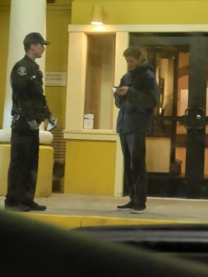 Daniel speaking to police outside an Olive Garden